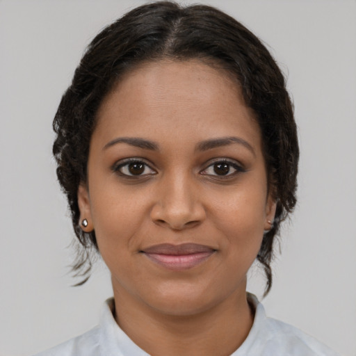 Joyful black young-adult female with medium  brown hair and brown eyes