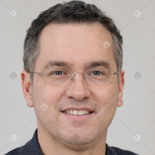 Joyful white adult male with short  brown hair and brown eyes