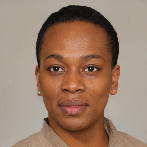 Joyful black young-adult female with short  black hair and brown eyes