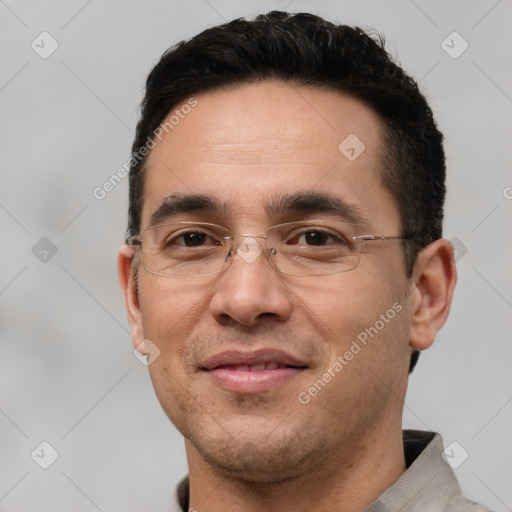 Joyful white adult male with short  black hair and brown eyes