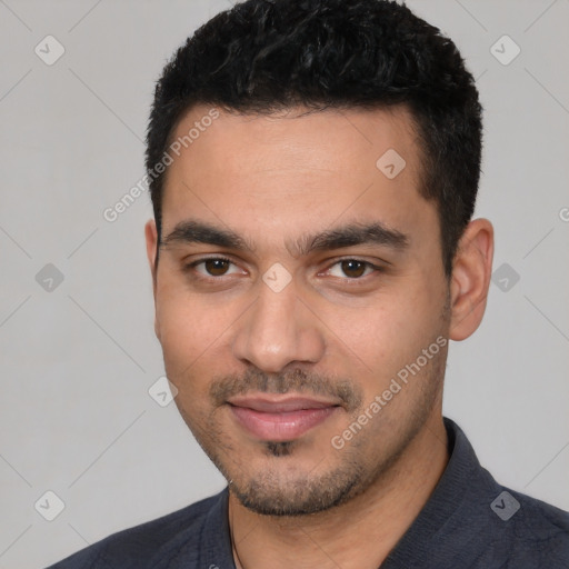 Joyful white young-adult male with short  black hair and brown eyes