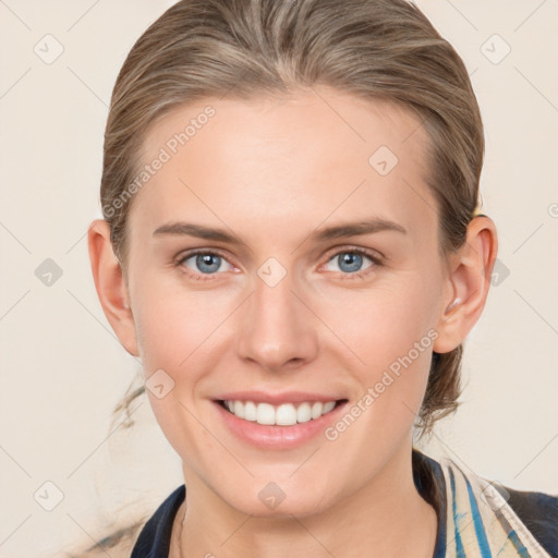 Joyful white young-adult female with medium  brown hair and blue eyes