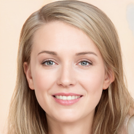 Joyful white young-adult female with long  brown hair and blue eyes