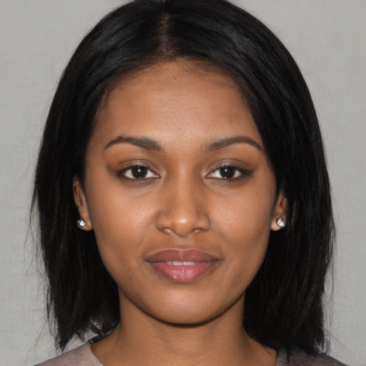 Joyful asian young-adult female with long  black hair and brown eyes