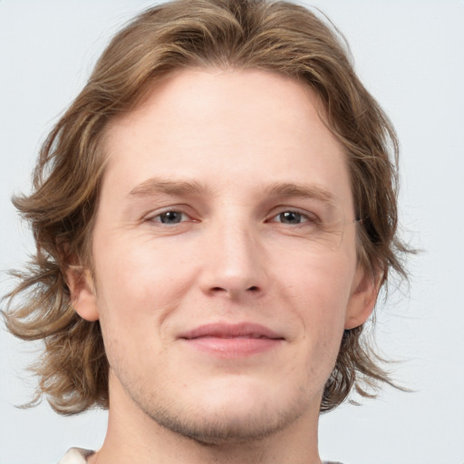 Joyful white young-adult male with medium  brown hair and grey eyes