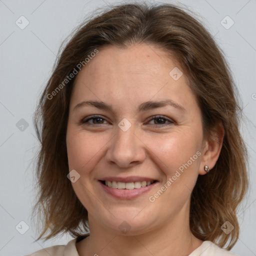 Joyful white adult female with medium  brown hair and brown eyes