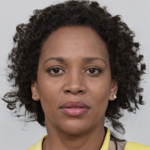 Joyful black adult female with short  brown hair and brown eyes