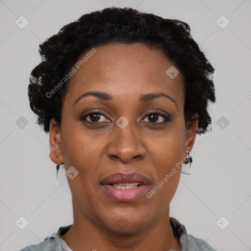 Joyful black adult female with short  black hair and brown eyes