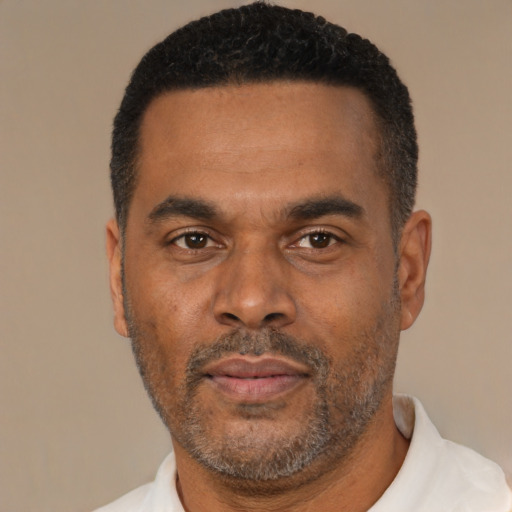 Neutral latino adult male with short  black hair and brown eyes