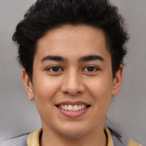 Joyful latino young-adult male with short  brown hair and brown eyes