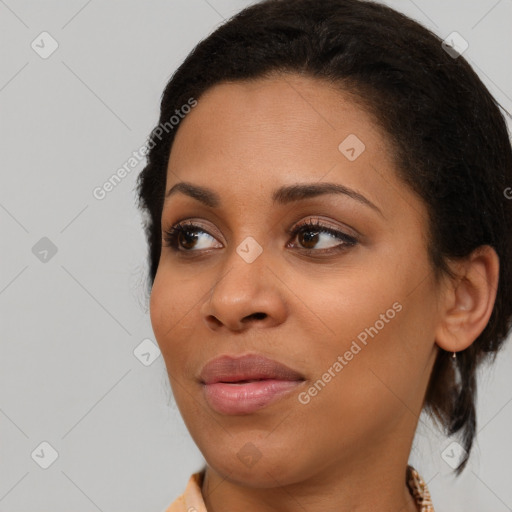 Joyful black young-adult female with medium  brown hair and brown eyes