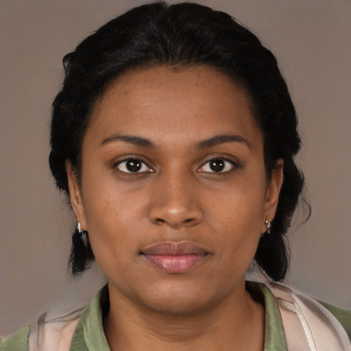 Joyful black young-adult female with medium  black hair and brown eyes