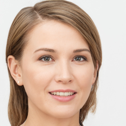 Joyful white young-adult female with long  brown hair and grey eyes