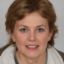 Joyful white young-adult female with medium  brown hair and blue eyes