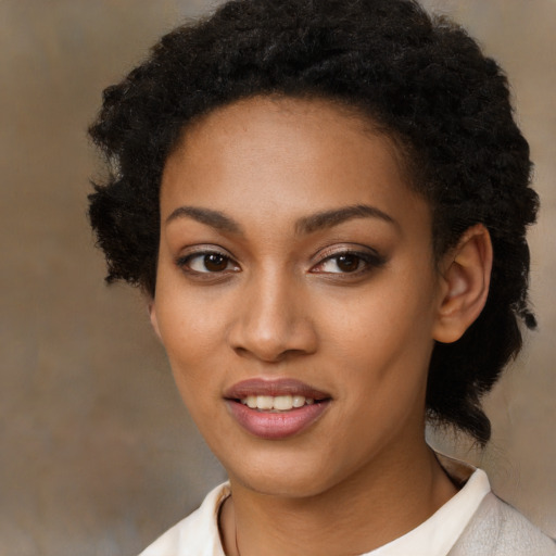Joyful black young-adult female with short  black hair and brown eyes