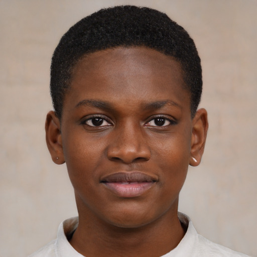 Joyful black child male with short  brown hair and brown eyes