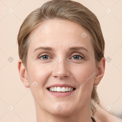 Joyful white young-adult female with short  brown hair and grey eyes