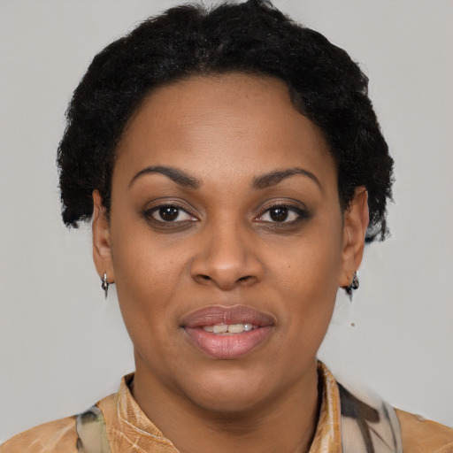 Joyful black adult female with short  brown hair and brown eyes