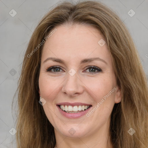 Joyful white young-adult female with long  brown hair and green eyes