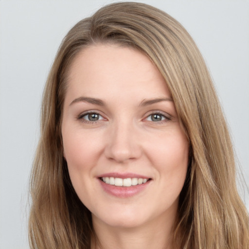 Joyful white young-adult female with long  brown hair and grey eyes