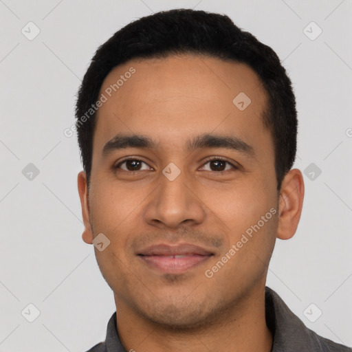 Joyful latino young-adult male with short  black hair and brown eyes