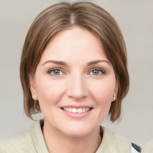 Joyful white young-adult female with medium  brown hair and blue eyes