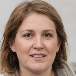 Joyful white adult female with medium  brown hair and grey eyes