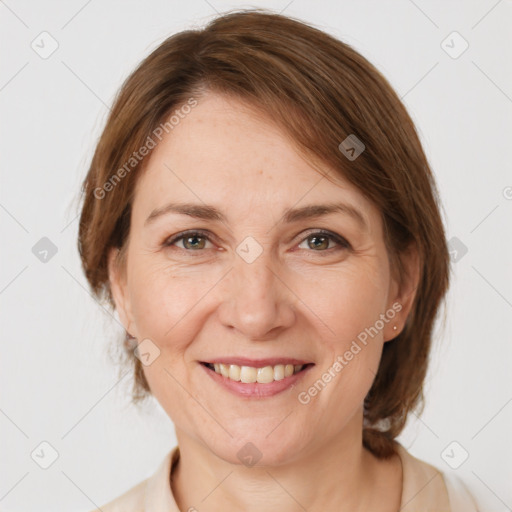 Joyful white adult female with medium  brown hair and grey eyes