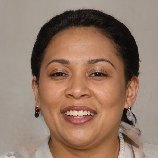 Joyful latino adult female with short  brown hair and brown eyes