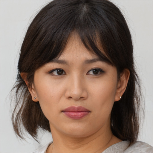 Neutral asian young-adult female with medium  brown hair and brown eyes