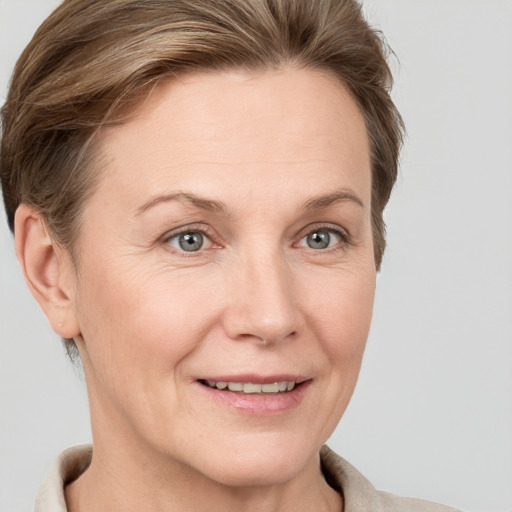 Joyful white adult female with short  brown hair and grey eyes