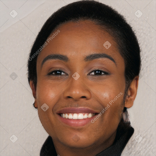 Joyful black young-adult female with long  brown hair and brown eyes