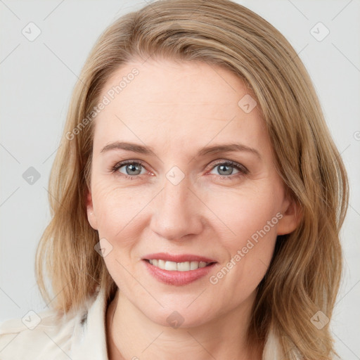 Joyful white young-adult female with medium  brown hair and blue eyes