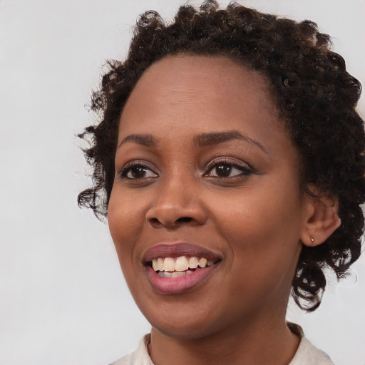 Joyful black young-adult female with medium  brown hair and brown eyes