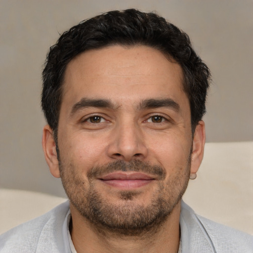 Joyful white adult male with short  brown hair and brown eyes