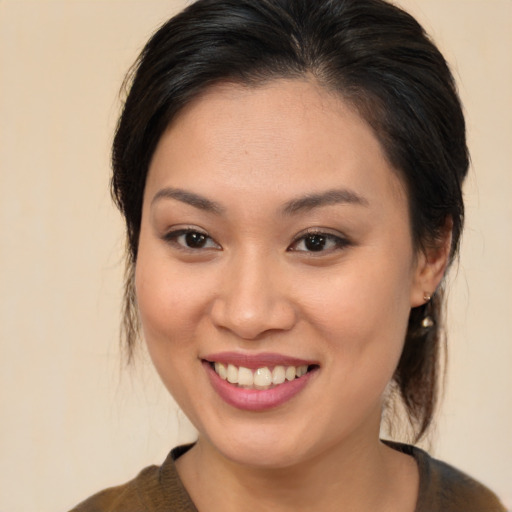 Joyful asian young-adult female with medium  brown hair and brown eyes