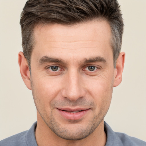 Joyful white adult male with short  brown hair and brown eyes