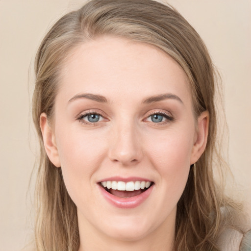 Joyful white young-adult female with long  brown hair and blue eyes