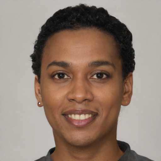 Joyful latino young-adult female with short  black hair and brown eyes
