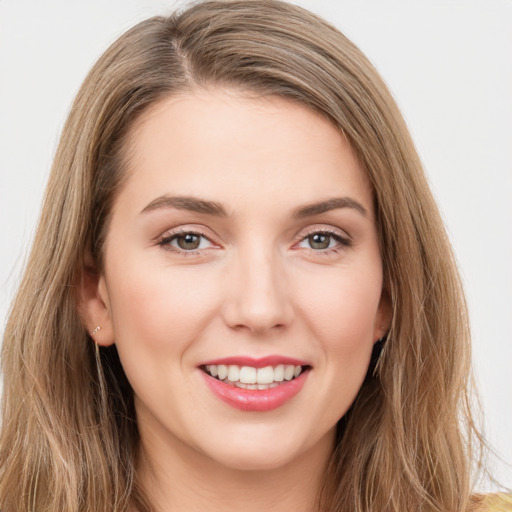 Joyful white young-adult female with long  brown hair and grey eyes