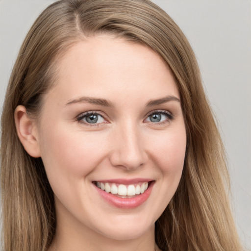 Joyful white young-adult female with long  brown hair and grey eyes