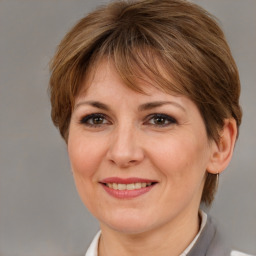 Joyful white adult female with medium  brown hair and brown eyes