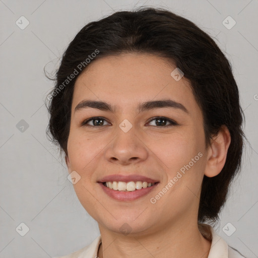 Joyful latino young-adult female with medium  brown hair and brown eyes