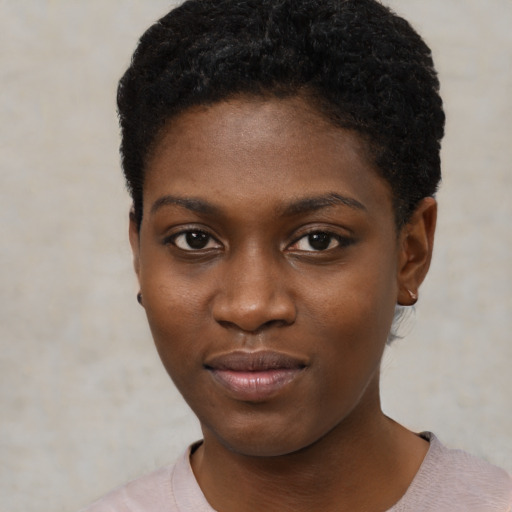 Joyful black young-adult female with short  black hair and brown eyes