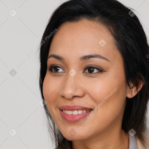 Joyful latino young-adult female with long  brown hair and brown eyes