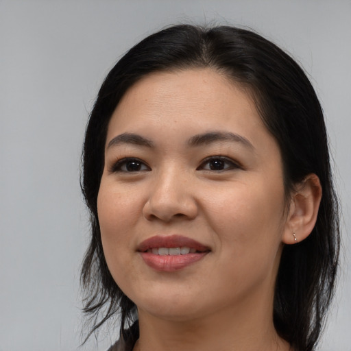 Joyful asian young-adult female with medium  black hair and brown eyes