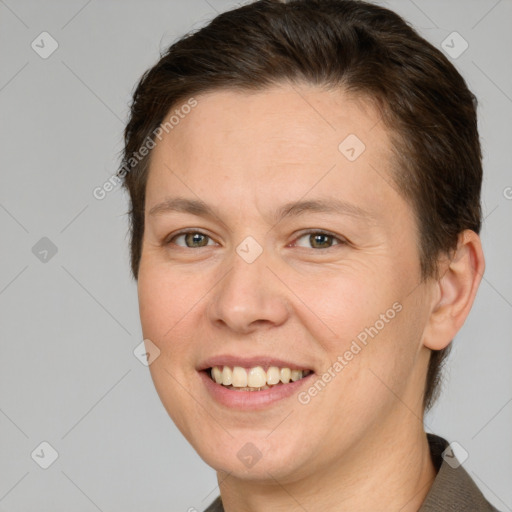 Joyful white adult female with short  brown hair and brown eyes