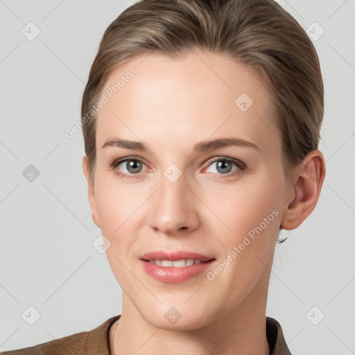 Joyful white young-adult female with short  brown hair and grey eyes