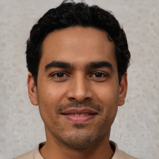 Joyful latino young-adult male with short  black hair and brown eyes