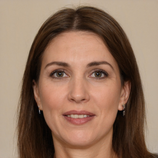 Joyful white adult female with long  brown hair and brown eyes